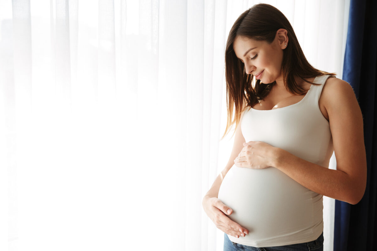 portrait-happy-pregnant-woman-touching-her-belly-1200x800.jpg